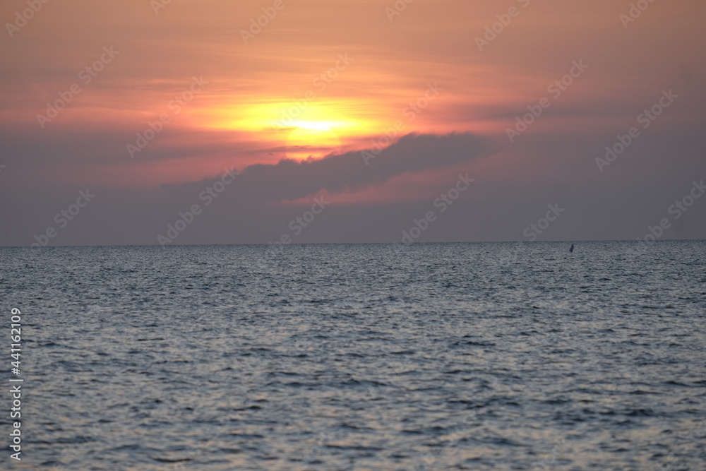 Beautiful sunset in early evening time with the dark sea.