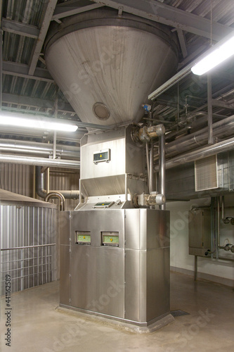 Interior of brewery, hopper and metal beer mashing tanks