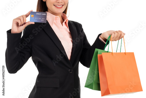Beautiful businesswoman with credit card and shopping bags isolated on white background
