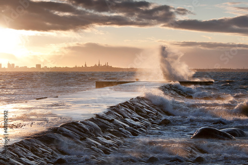 A weather storm in the Baltic Sea, waves crashing over a pier  photo