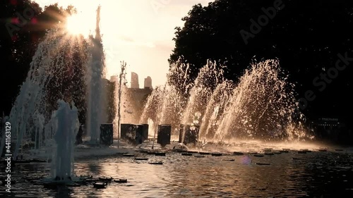 Beautiful sunset at fountain. City landscape, slow motion
