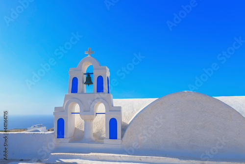 Greece Santorini island in Cyclades, traditional view of white washed houses with colorful wooden frames photo