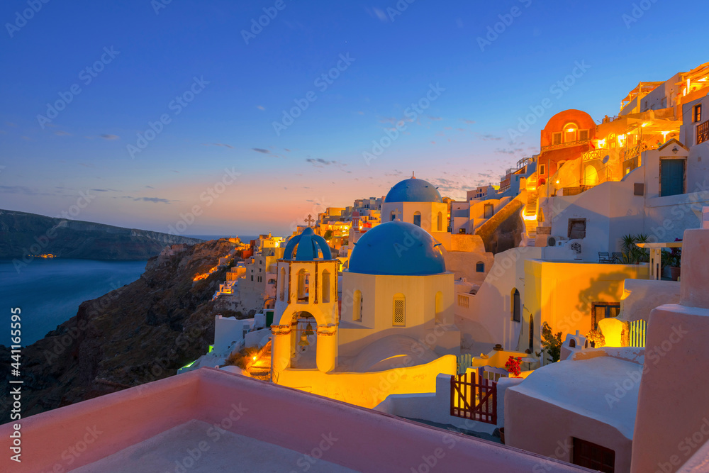 Greece Santorini island in Cyclades, wide view of white washed colorful houses at night