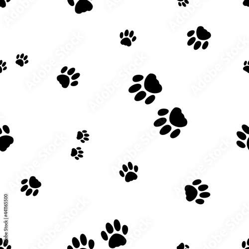 Seamless vector pattern with footprint of cat`s paws. Black paws of cats and kittens on the white background. Seamless pattern with silhouettes of paws of pets.
