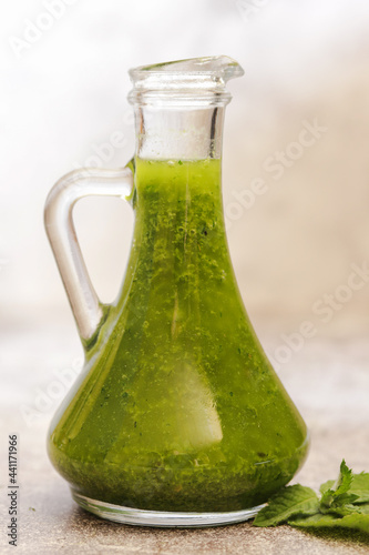 Handmade green oil and fresh herbs and spices.