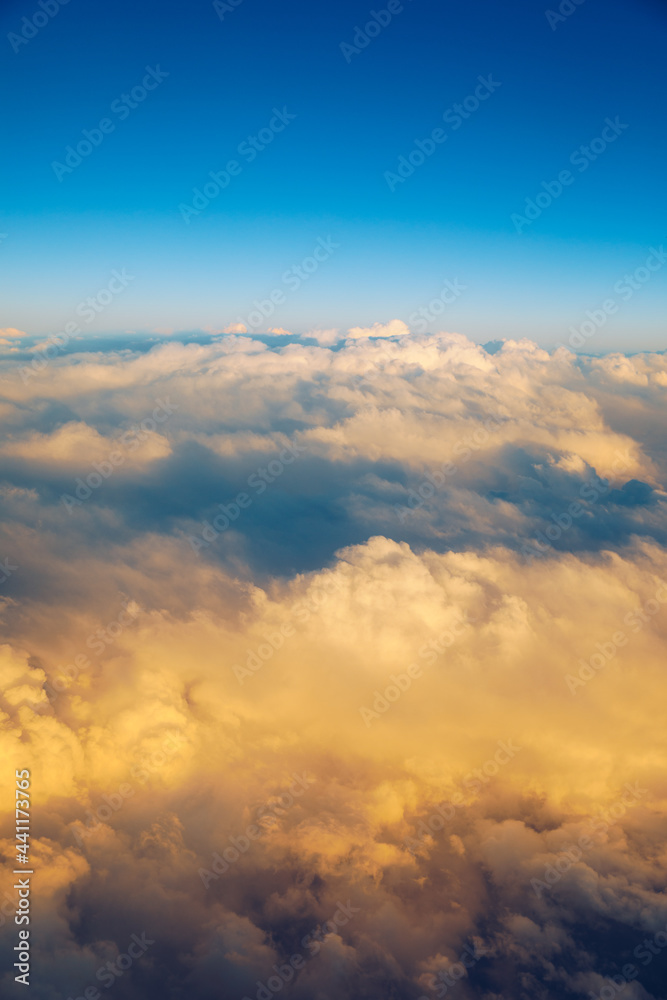 Sunny sky abstract background, beautiful cloudscape, on the heaven, view over white fluffy clouds, freedom concept. Aerial view of sky and white clouds. View from airplane. Sunny sky abstract background, beautiful cloudscape, on the heaven, view over white fluffy clouds, freedom concept. Aerial view of sky and white clouds. View from airplane.