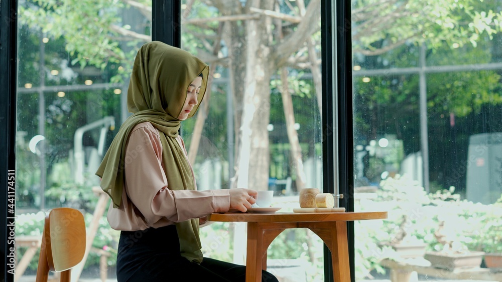 Young muslim drink coffee with bakery in coffee shop Young muslim drink coffee with bakery in coffee shop