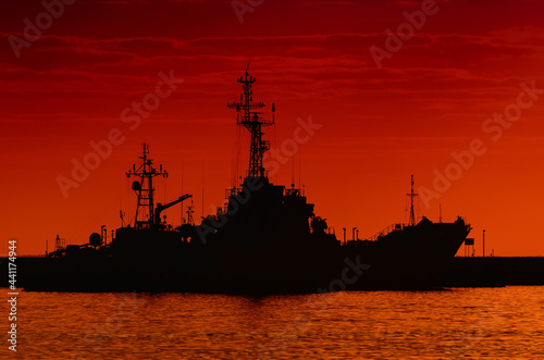 WARSHIPS - A fiery sunrise over the naval base 