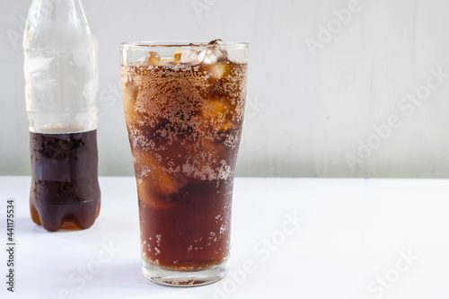 .Glass of soft drinks and black soft drinks on the table