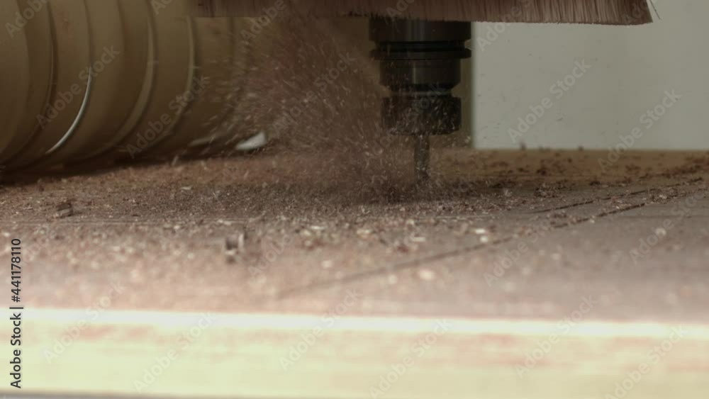 Close-up of CNC machine cutting piece of plywood, Nottingham, UK Close-up of CNC machine cutting piece of plywood, Nottingham, UK