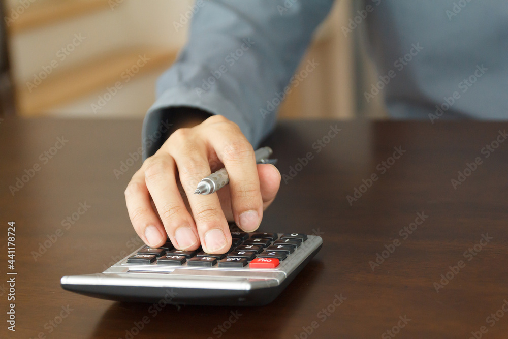 Close up hand man use calculator to calculate something Close up hand man use calculator to calculate something