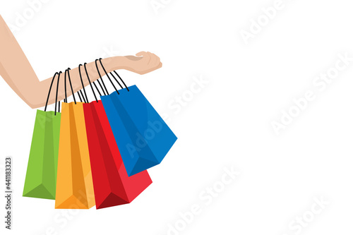 Woman hand holding colorful shopping bag. vector illustration flat design. isolated on white background. business and finance concept. marketing and buy goods. copy space for text input.
