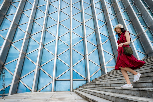 Asian woman in red dress at...