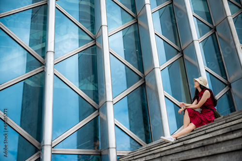 Asian woman in red dress at...