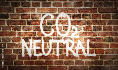 CO2 Neutral climate, environment and ecology crisis spray painted inscription on the brick wall © PerlaStudio