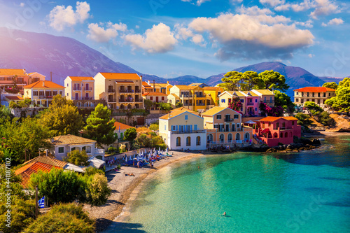 Assos village in Kefalonia, Greece. Turquoise colored bay in Mediterranean sea with beautiful colorful houses in Assos village in Kefalonia, Greece, Ionian island, Cephalonia, Assos village.