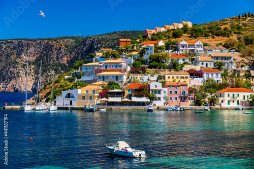 Assos village in Kefalonia, Greece. Turquoise colored bay in Mediterranean sea with beautiful colorful houses in Assos village in Kefalonia, Greece, Ionian island, Cephalonia, Assos village. © daliu