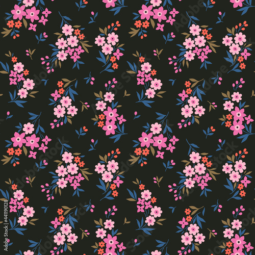 Beautiful floral pattern in small abstract flowers. Small light pink flowers. Black background. Ditsy print. Floral seamless background. The elegant the template for fashion prints. Stock pattern.