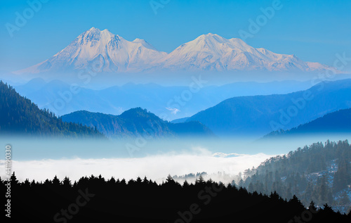 Beautiful landscape with cascade blue mountains at the morning - View of wilderness mountains during foggy weather