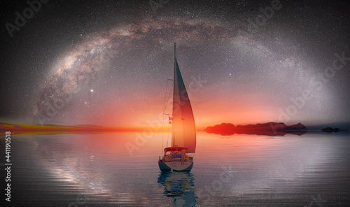 Lone sailing luxur yacht under starry night sky with milkyway galaxy © muratart