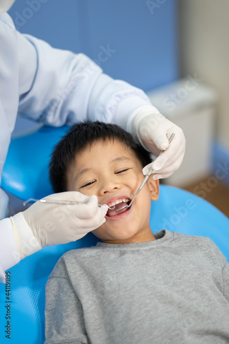 Asian kid check up with dentist at the dental clinic. Concept of dental check up and healthcare