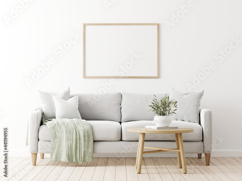 Fototapeta Naklejka Na Ścianę i Meble -  Horizontal poster mockup with wooden frame in living room interior with grey sofa, pillows, green throw, olive twigs in vase and coffee table on empty wall background. 3D rendering, illustration