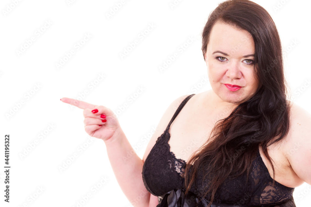 Naklejka premium Woman plus size in lingerie pointing at copy space