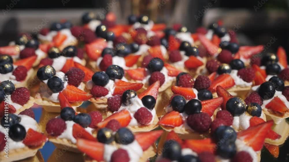Very tasty baskets with cream and berries on the buffet table for a festive event. Very tasty baskets with cream and berries on the buffet table for a festive event.
