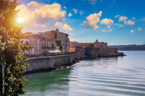 Fototapeta Naklejka Na Ścianę i Meble -  Siracusa, Ortigia Island, Sicily, Italy. Isola di Ortigia, coast of Ortigia island at city of Syracuse, Sicily, Italy. Coastline town Syracuse, Sicily and old Ortigia island.