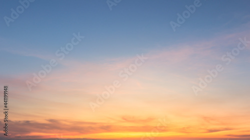 Fototapeta Naklejka Na Ścianę i Meble -  Beautiful Vivid sky painted by the sun leaving bright golden shades.Dense clouds in twilight sky in winter evening.Image of cloud sky on evening time.Evening Vivid sky with clouds.