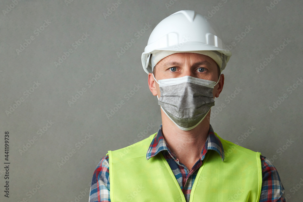 Worker man wearing face mask and protective hard hat