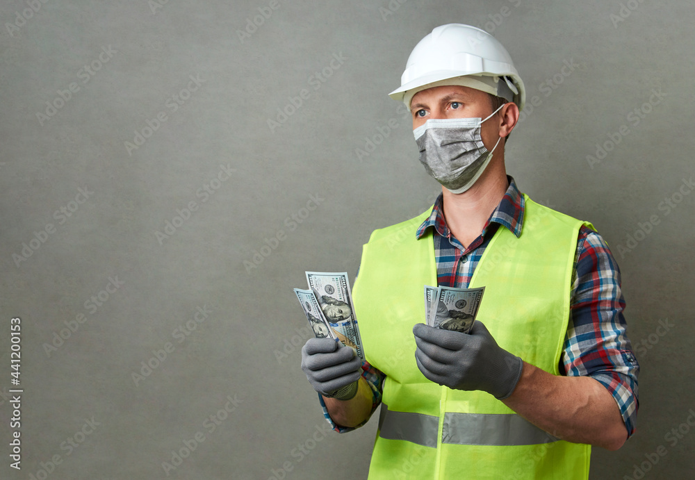 Construction worker counting money Construction worker counting money