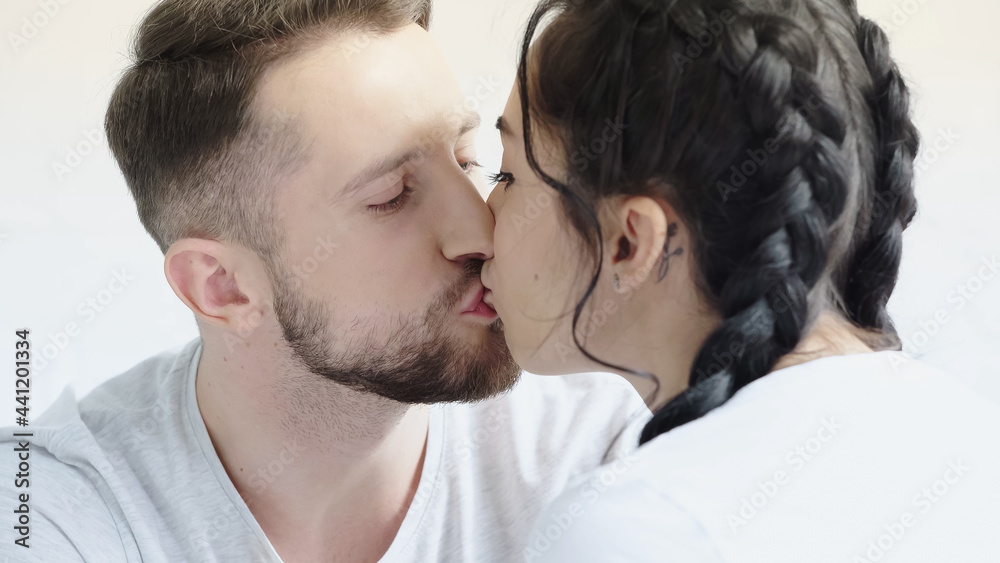 young woman with braids and man kissing at home. young woman with braids and man kissing at home.