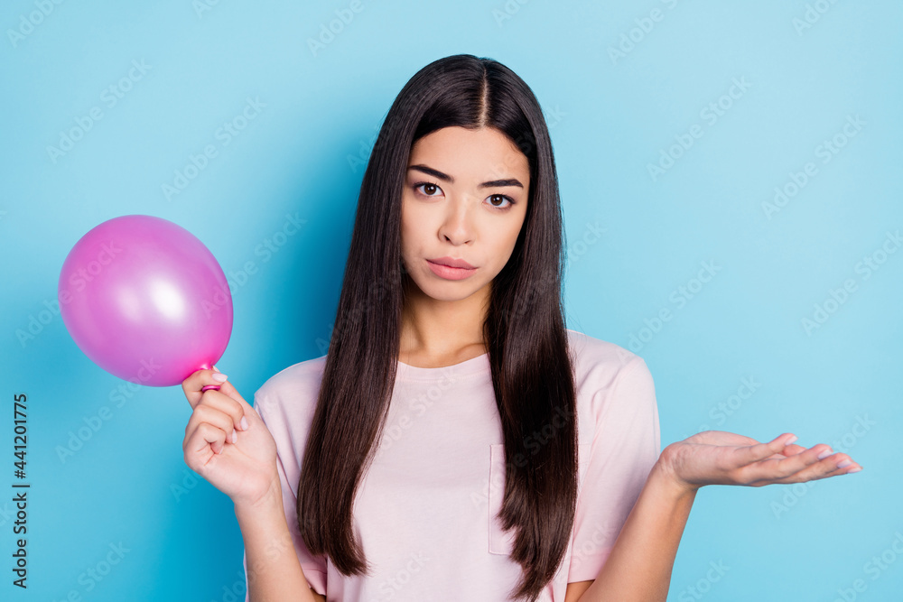 Portrait of attractive clueless girl holding air ball no idea prepare isolated over bright blue color background Portrait of attractive clueless girl holding air ball no idea prepare isolated over bright blue color background