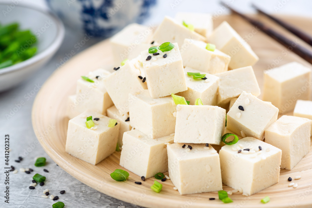 Tofu cubes on bamboo plate. Healthy asian food