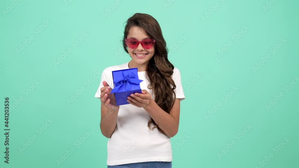 happy amazed child in sunglasses hold present box, amazement