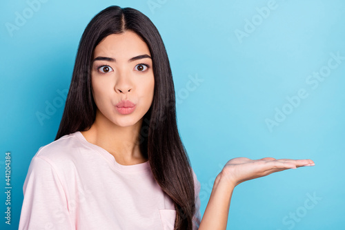 Photo of young girl pouted lips demonstrate product promo offer suggest isolated over blue color background