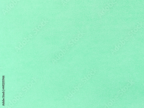 mint green velvet fabric texture used as background. Empty light orange fabric background of soft and smooth textile material. There is space for text.