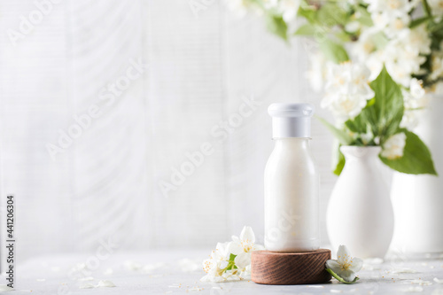 Cosmetic detergent with jasmine extract. Mockup of cream  shampoo  soap. Copy space.