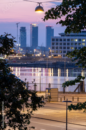 Beautiful night cityscape with tall highrise buildings in the background. photo