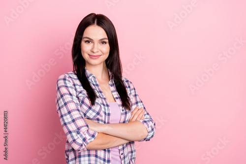 Portrait of lovely content cheerful girl wearing checked shirt folded arms isolated over pink pastel color background © deagreez