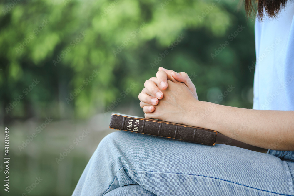 Hands of woman Pray for god blessing with the bible on a natural background. begging for forgiveness and believe in goodness. Christian life crisis prayer and worship to god.
