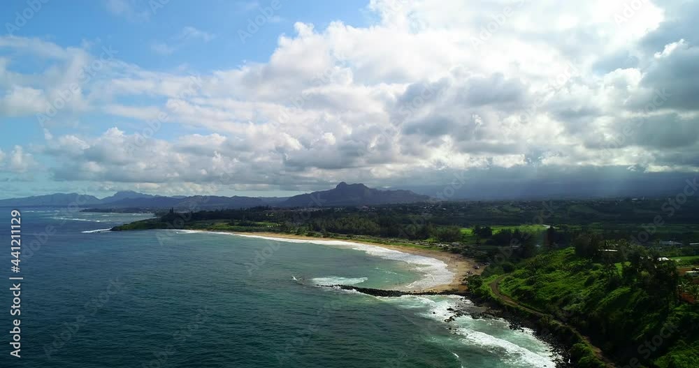 Aerial Forward Shot Of Tourist At Vacation On Beach, Drone Flying Over Sea By Landscape Against Cloudy Sky - Kauai, Hawaii Aerial Forward Shot Of Tourist At Vacation On Beach, Drone Flying Over Sea By Landscape Against Cloudy Sky - Kauai, Hawaii