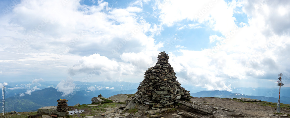 Fototapeta premium A pile of stones on a mountain top in the carpathian mountains in summer