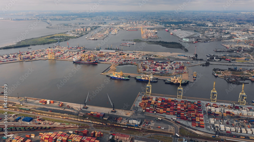 Obraz premium Aerial view of high-tech modern seaport with cranes and loaders