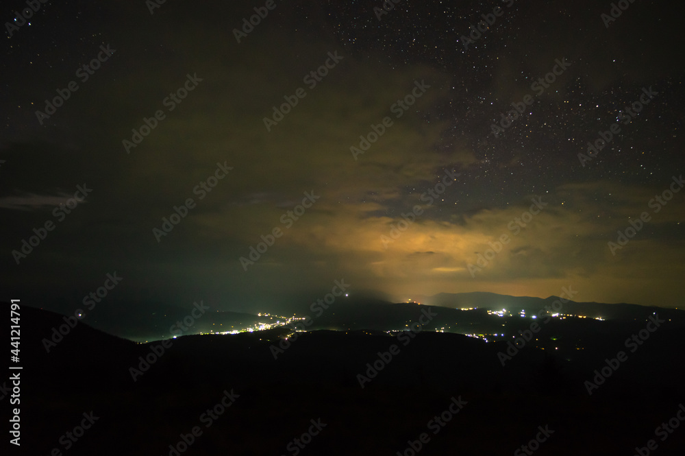 Beautiful starry sky over the village in the Ukrainian Carpathians. Night landscape Beautiful starry sky over the village in the Ukrainian Carpathians. Night landscape