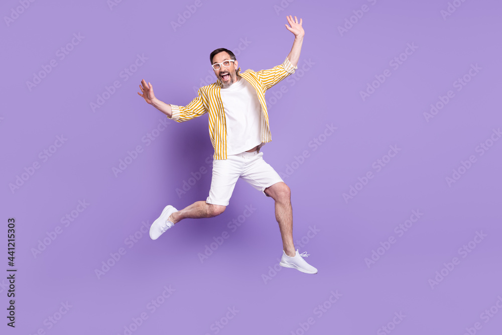 Photo of funky childish age gentleman wear striped shirt spectacles jumping high smiling isolated violet color background