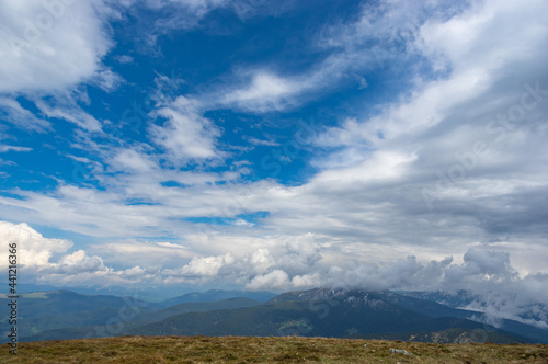 Green meadow and blue sky in the Carpathian mountains in Ukraine