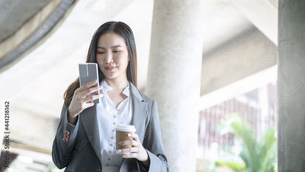 Obraz premium Happy Confident young asian businesswoman use the smartphone. business successful technology