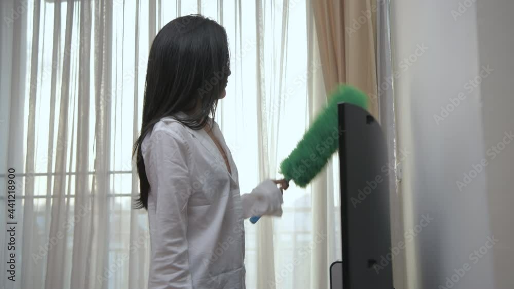 Holiday concept of 4k Resolution. Asian girls cleaning the furniture in the living room. Holiday concept of 4k Resolution. Asian girls cleaning the furniture in the living room.